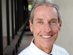 older man smiling with dentures