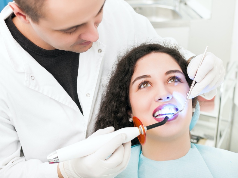 New York Dentist Doing Teeth Whitening Procedure On Woman's Teeth